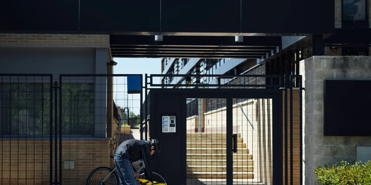 Man opens backpack in front of the gate