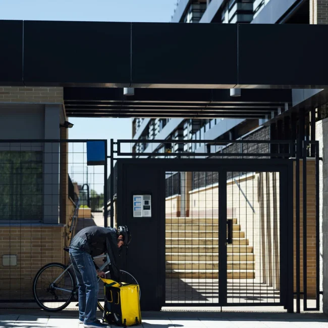 Man opens backpack in front of the gate